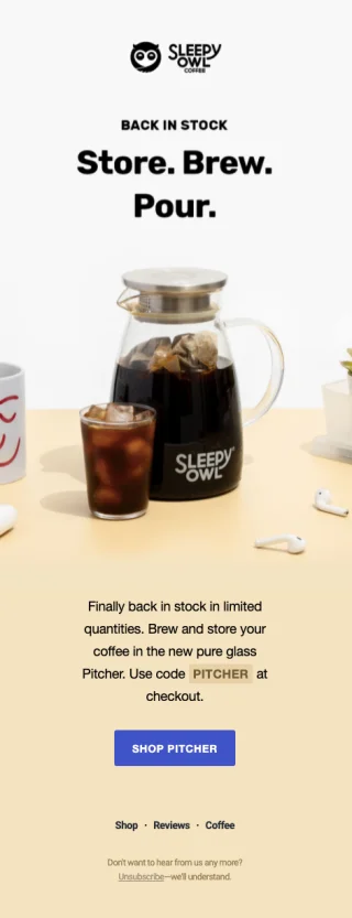 A Sleepy Owl coffee pot and mug with coffee and ice, accompanied by white earbuds on a light wooden surface. Text reads “Sleepy Owl Store. Brew. Pour.” and “Finally back in stock in limited quantities. Brew and store your coffee using the new pure glass Pitcher. Use code PITCHER at checkout.”